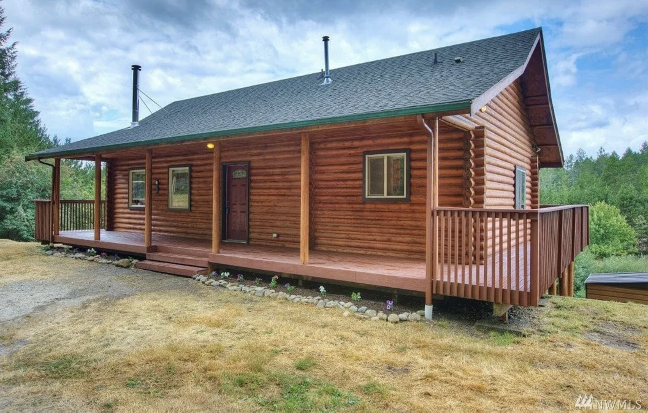 Port Orchard log cabin home with wraparound deck